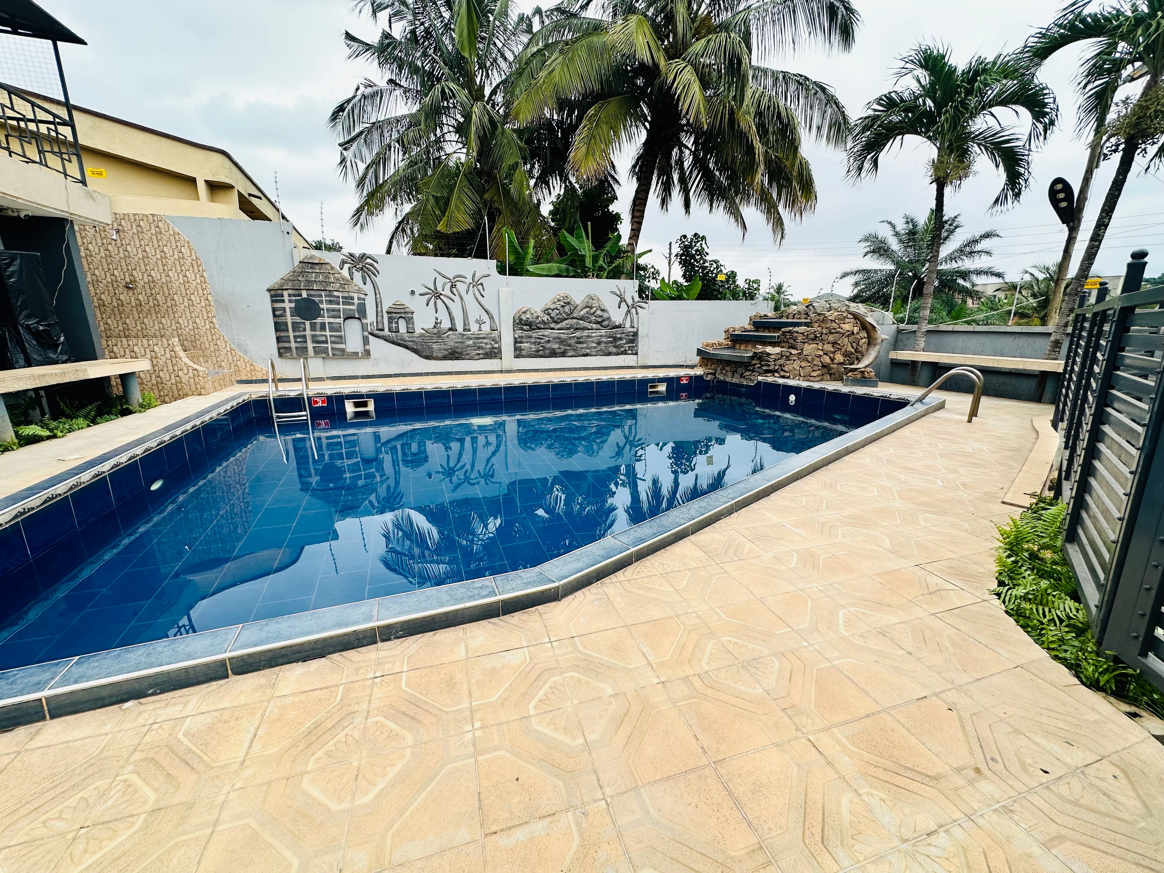 Poolside garden with African relief mural